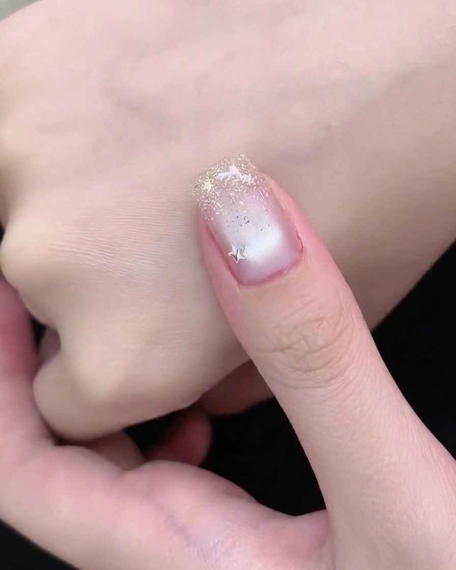 Dłoń spoczywająca pod lampą UV lub LED podczas końcowego etapu utwardzania manicure.