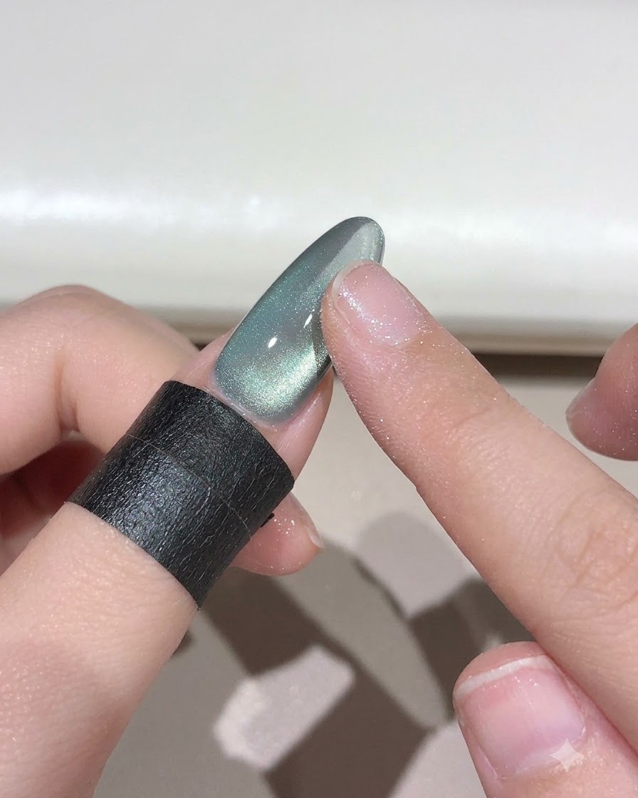 Ein Finger reibt Himmel-zu-Reich-Magiepulver auf einen Nagel, um einen Verlaufeffekt zu erzeugen.