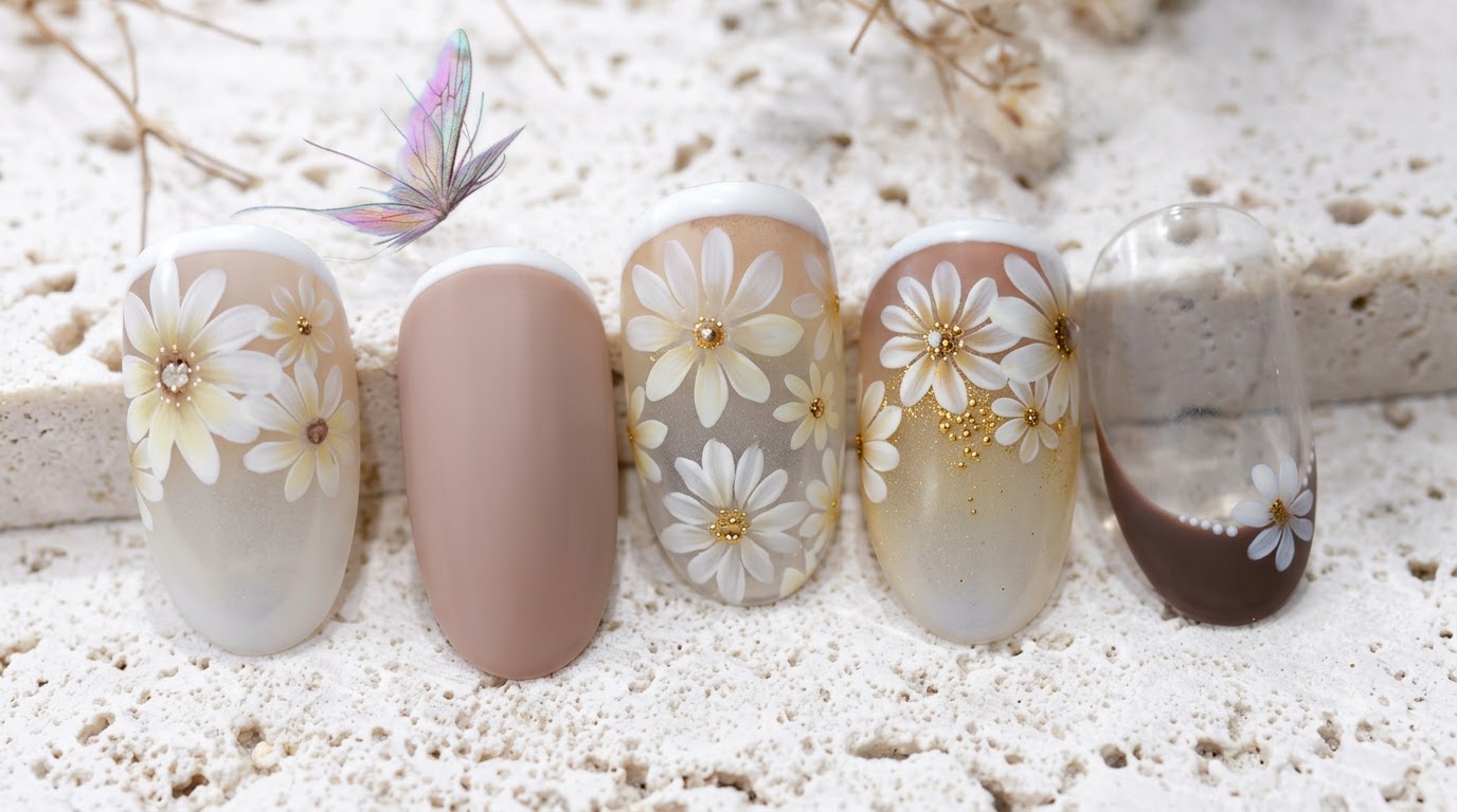 Gotowy manicure z motywem margaritki na mlecznych, nude i brązowych odcieniach z delikatnymi białymi kwiatami.