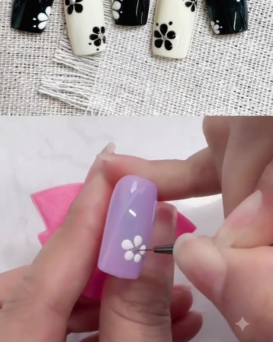 Cienki pędzelek liniowy przeciągający kropki białego żelu do wewnątrz, aby uformować płatki na fioletowym paznokciu.