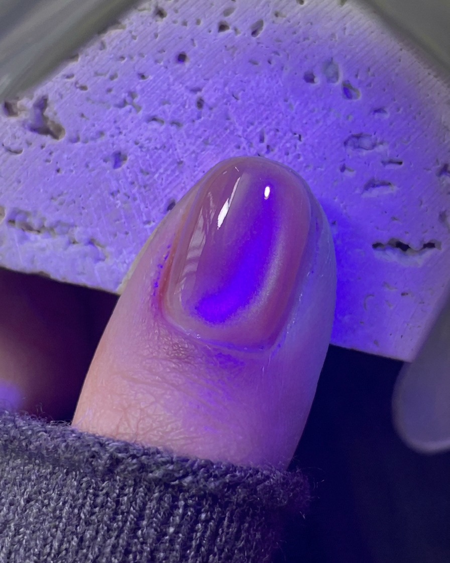 Paznokieć utwardzający się pod fioletową minilampą UV i LED.